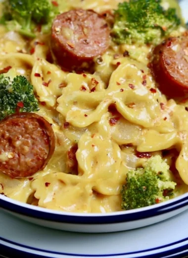 Cozy smoked sausage cheddar pasta served in a bowl, garnished with herbs