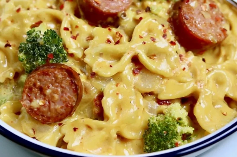 Cozy smoked sausage cheddar pasta served in a bowl, garnished with herbs