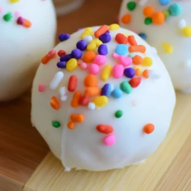 Cozy no-bake cake batter truffles topped with colorful sprinkles