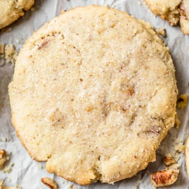 Cozy homemade Pecan Sandies cookies arranged on a plate.