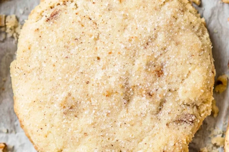 Cozy homemade Pecan Sandies cookies arranged on a plate.