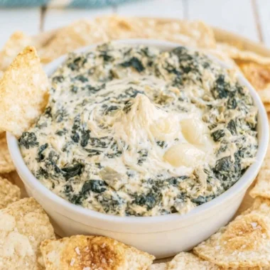 Creamy slow cooker spinach artichoke dip served in a bowl