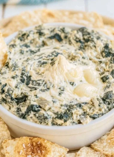Creamy slow cooker spinach artichoke dip served in a bowl