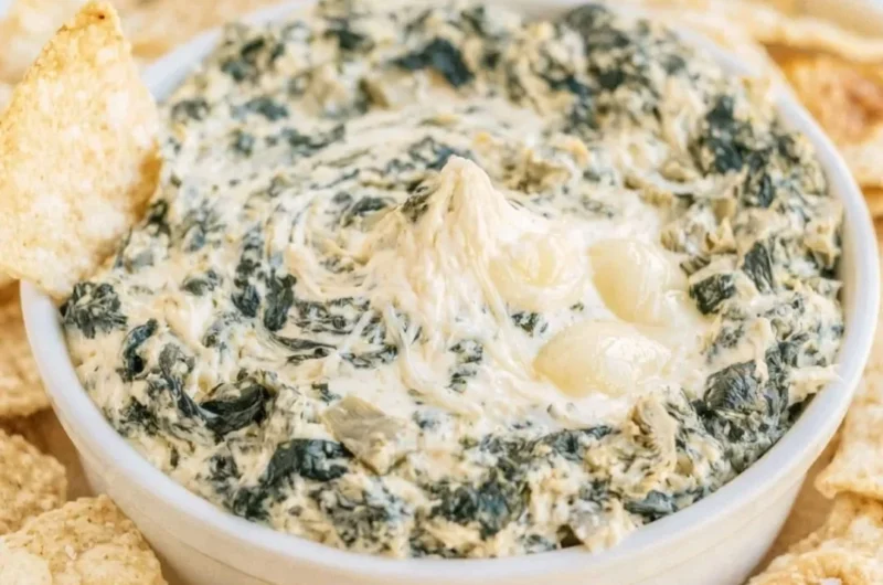 Creamy slow cooker spinach artichoke dip served in a bowl