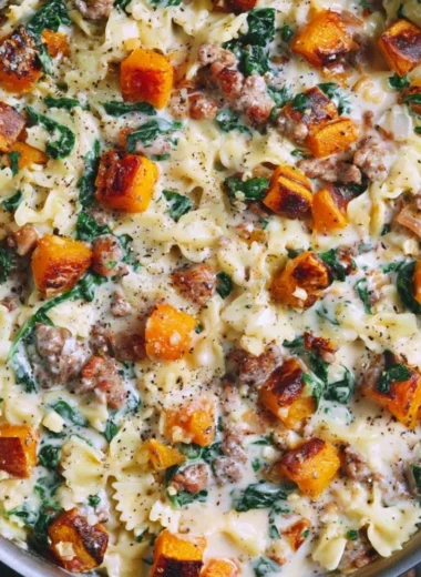 Creamy butternut squash pasta with sausage and spinach served in a bowl
