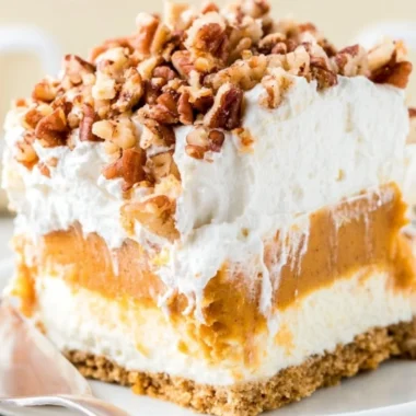 Delicious Pumpkin Lush dessert topped with whipped cream and pumpkin spice