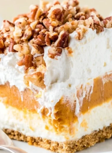 Delicious Pumpkin Lush dessert topped with whipped cream and pumpkin spice