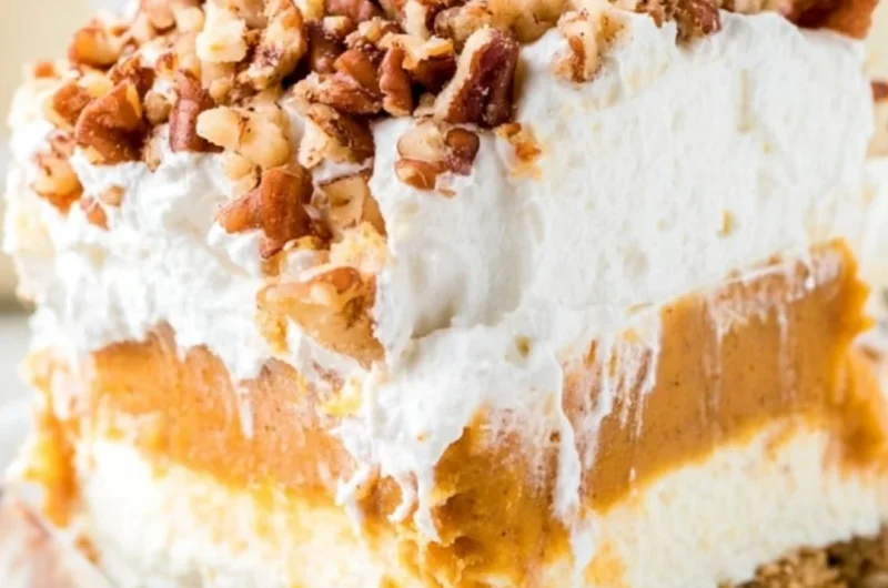 Delicious Pumpkin Lush dessert topped with whipped cream and pumpkin spice