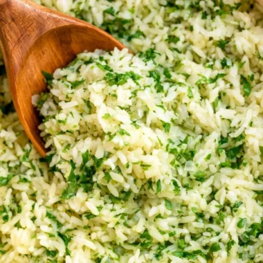 Delicious cilantro lime rice served in a bowl, garnished with fresh cilantro.