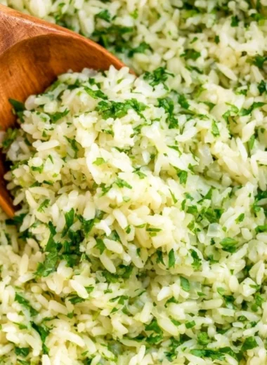 Delicious cilantro lime rice served in a bowl, garnished with fresh cilantro.