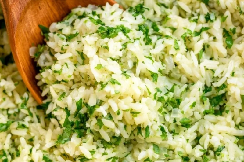 Delicious cilantro lime rice served in a bowl, garnished with fresh cilantro.
