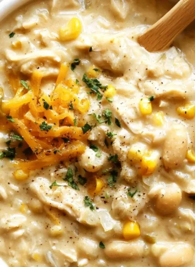 Bowl of cozy white chicken chili topped with cilantro and lime