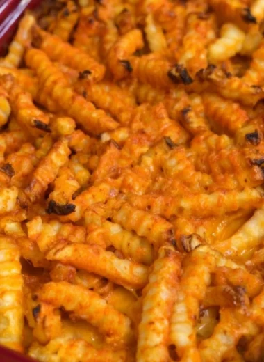 Cheeseburger French Fry Casserole topped with melted cheese and crispy fries
