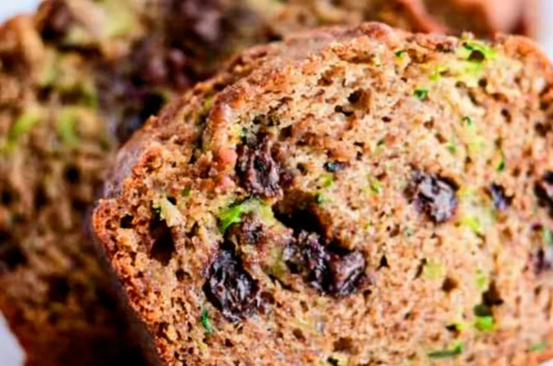 Delicious slice of chocolate chip zucchini bread on a wooden cutting board