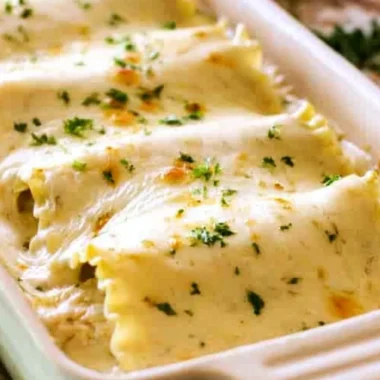 Creamy Chicken Alfredo Roll Ups served on a plate with garnish