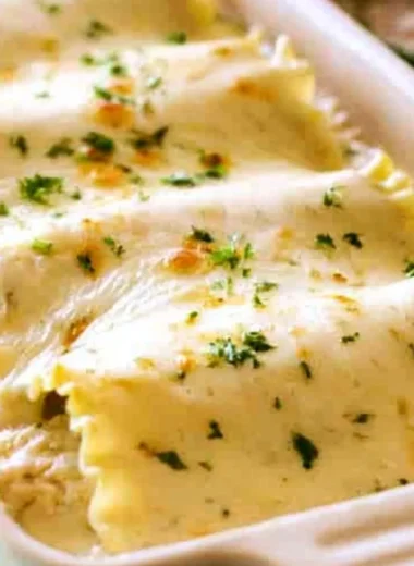 Creamy Chicken Alfredo Roll Ups served on a plate with garnish