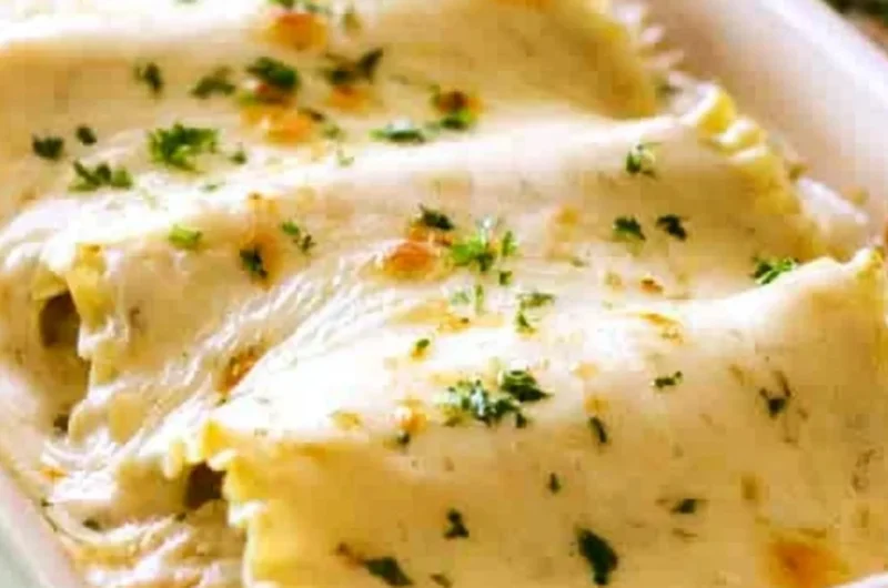 Creamy Chicken Alfredo Roll Ups served on a plate with garnish