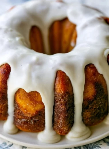 Delicious homemade cinnamon roll bundt cake with icing on a serving plate