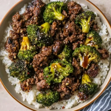 Cozy ground beef and broccoli stir-fry served in a bowl with chopsticks.
