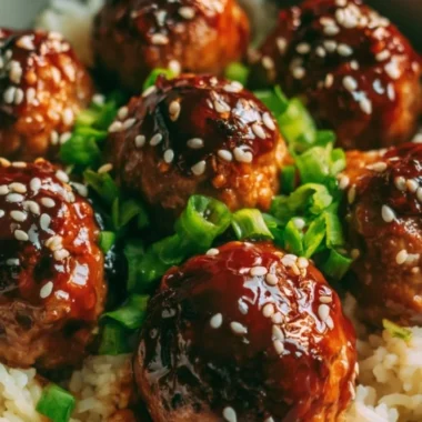 Delicious Asian meatballs served in a bowl with sauce and garnish.