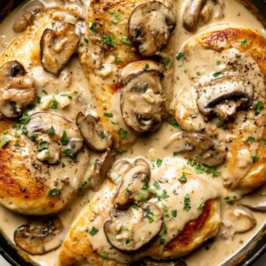 Plate of creamy white wine chicken garnished with herbs