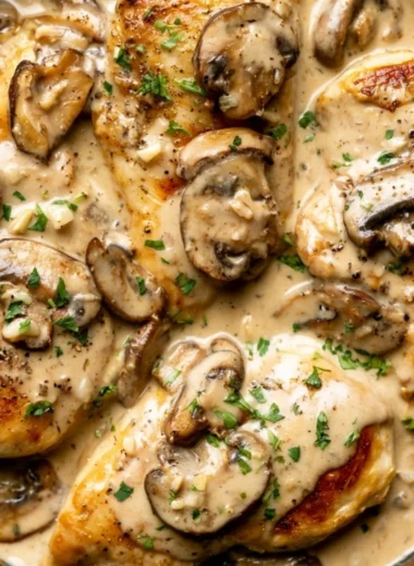 Plate of creamy white wine chicken garnished with herbs