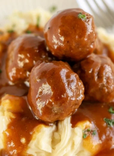 Cozy slow cooker Salisbury steak meatballs served with gravy and mashed potatoes