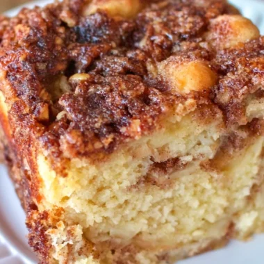 Deliciously moist apple sour cream cake topped with fresh apples and a creamy glaze