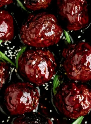 Plate of sticky Mongolian beef meatballs garnished with green onions