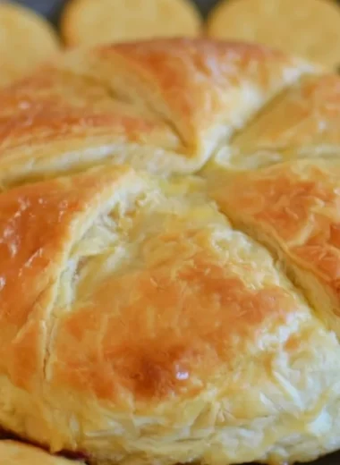 Baked brie in puff pastry served with fruits and nuts