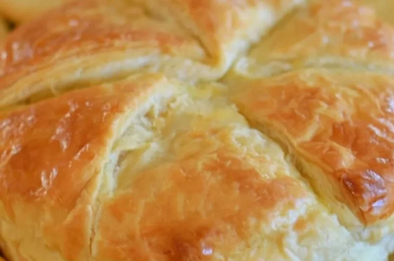 Baked brie in puff pastry served with fruits and nuts