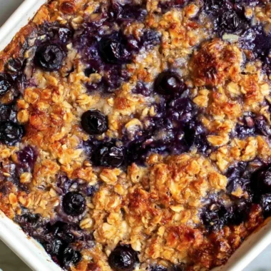 Delicious blueberry baked oatmeal served in a bowl with fresh blueberries on top.