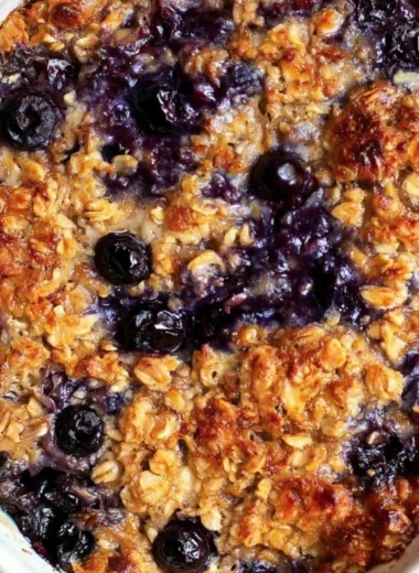 Delicious blueberry baked oatmeal served in a bowl with fresh blueberries on top.