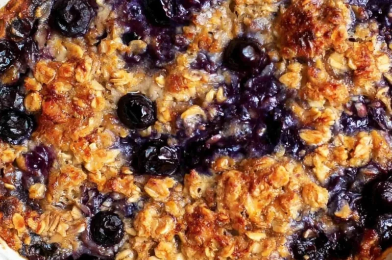 Delicious blueberry baked oatmeal served in a bowl with fresh blueberries on top.