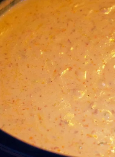 Delicious chorizo cheese dip served in a crockpot with tortilla chips.