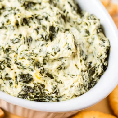 Delicious easy hot spinach dip served in a bowl with bread and vegetables