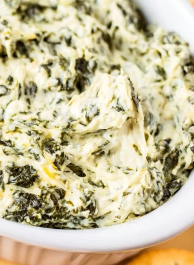 Delicious easy hot spinach dip served in a bowl with bread and vegetables