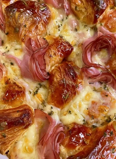 Delicious croissant bake casserole served on a plate, ready for dinner.