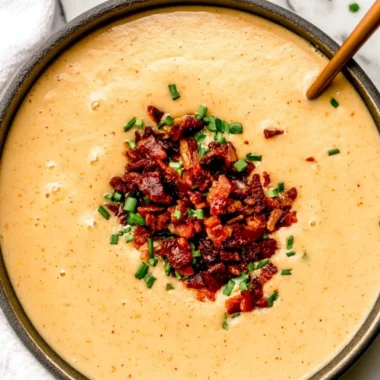 High-protein cream of potato soup served in a white bowl with fresh herbs