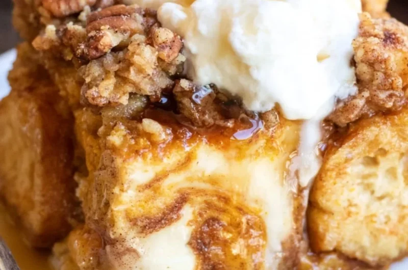 Pumpkin French Toast Casserole topped with syrup and whipped cream