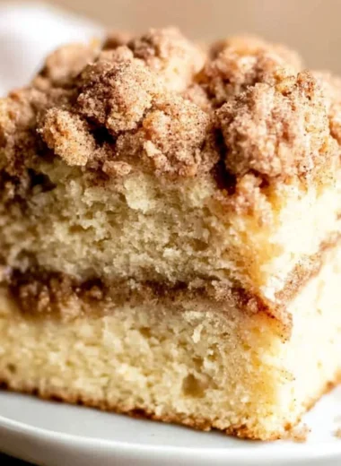 Sour cream coffee cake with cinnamon on a decorative plate.