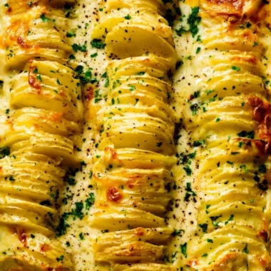 Deliciously creamy and cheesy scalloped potatoes topped with herbs.
