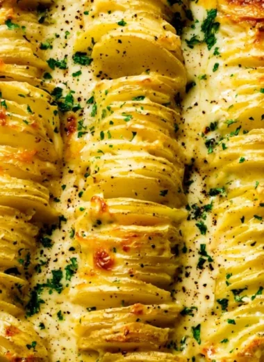 Deliciously creamy and cheesy scalloped potatoes topped with herbs.