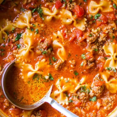 Delicious bowl of the world's best lasagna soup garnished with cheese and herbs.