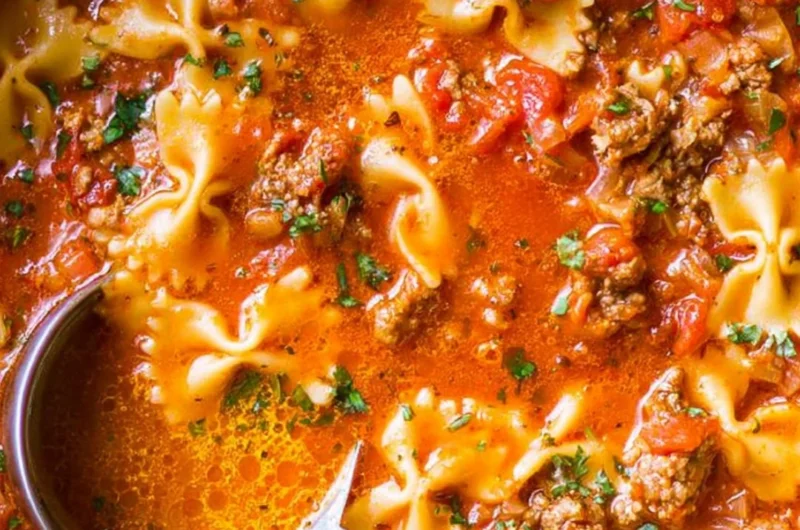 Delicious bowl of the world's best lasagna soup garnished with cheese and herbs.